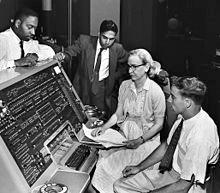 Grace Hopper invents one of the first compiler-related tools and popularizes the idea of machine-independent languages, which leads to the development of COBOL.